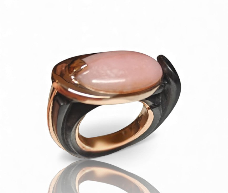 Top view of Modern Muse pink opal ring in polished 14K pink gold with hand carved ebony wood base by Konforti Jewelry