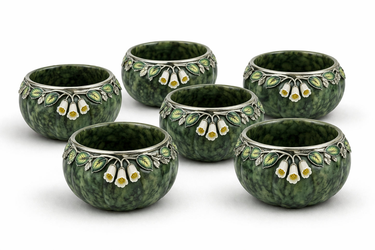 Set of six nephrite jade tea cups with hand carved white jade bluebell flowers, yellow sapphire centers, and silver enamel leaf ornamentation