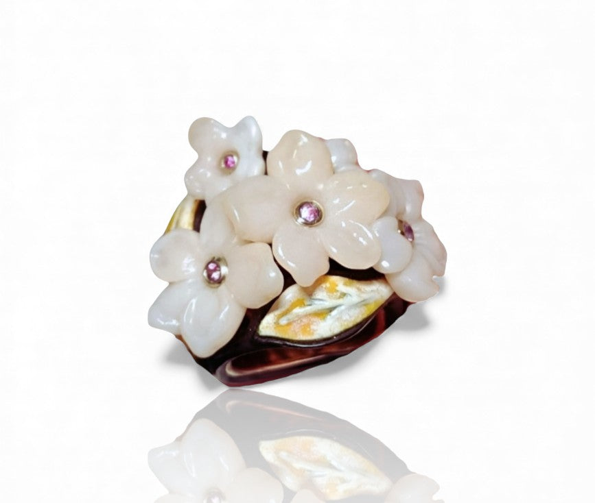 Standalone image of the Pink Sakura ring showcasing the carved pink opal flowers, 0.2ct pink sapphire centers set in 18K white gold, hot enamel painting over 18K yellow gold, a 14K pink gold inner band, and a hand-carved black ebony wood outer base.