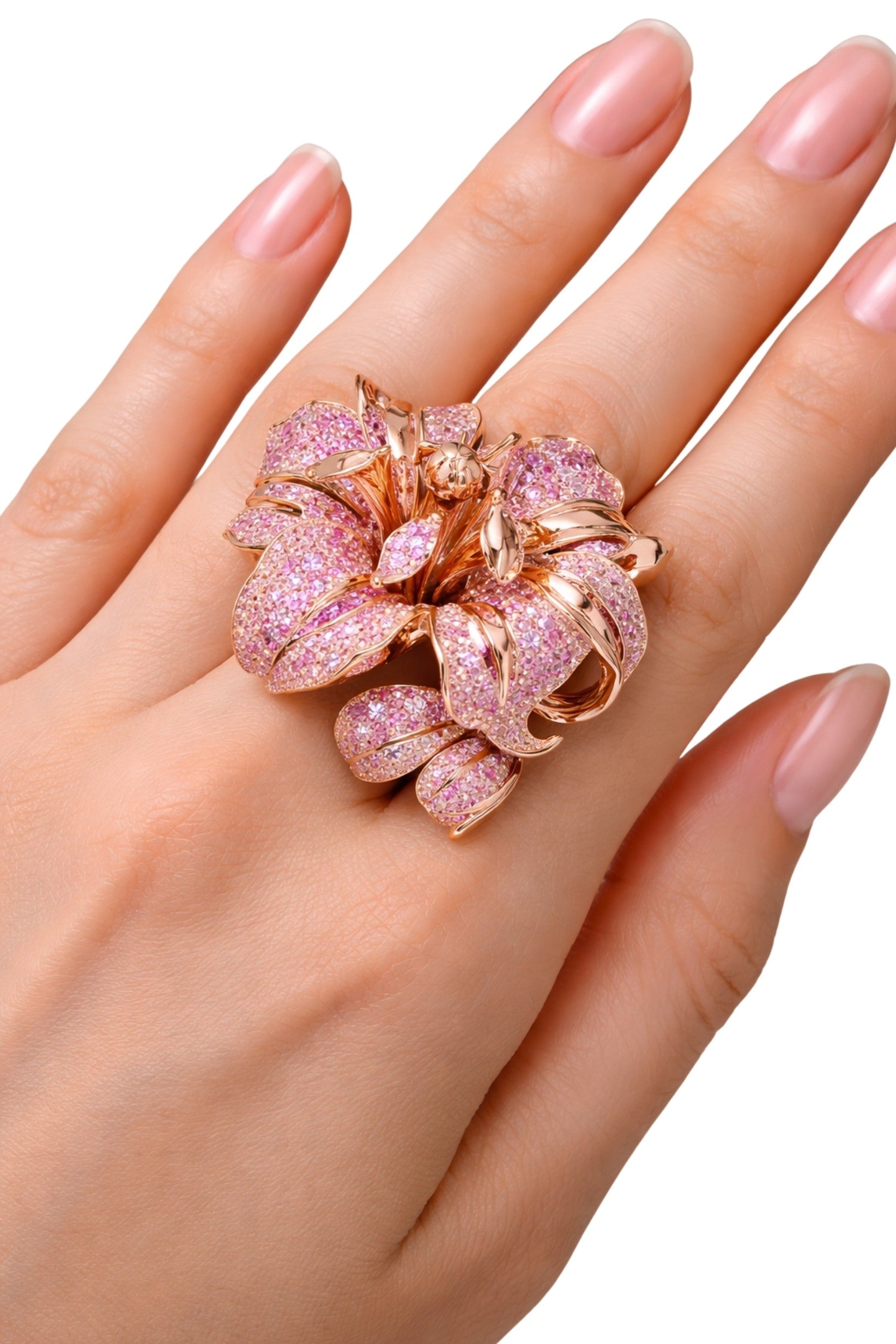 Blushing Bloom floral cocktail ring worn on hand in 14K rose gold with pink and peach sapphire pavé petals