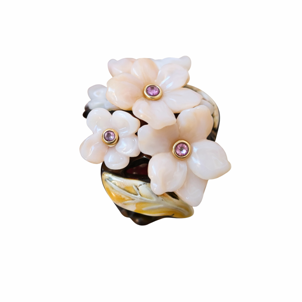Side view of Pink Sakura ring showing carved pink opal flowers pink sapphires gold enamel leaf and ebony wood base by Konforti Jewelry