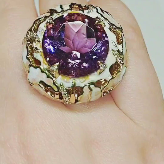On-hand video of the ametrine lily ring, showcasing the 32 ct ametrine gemstone, hand-painted enamel lilies set with pink sapphires, and sparkling 0.34 ct diamond accents in an artisan statement design by Konforti Jewelry.