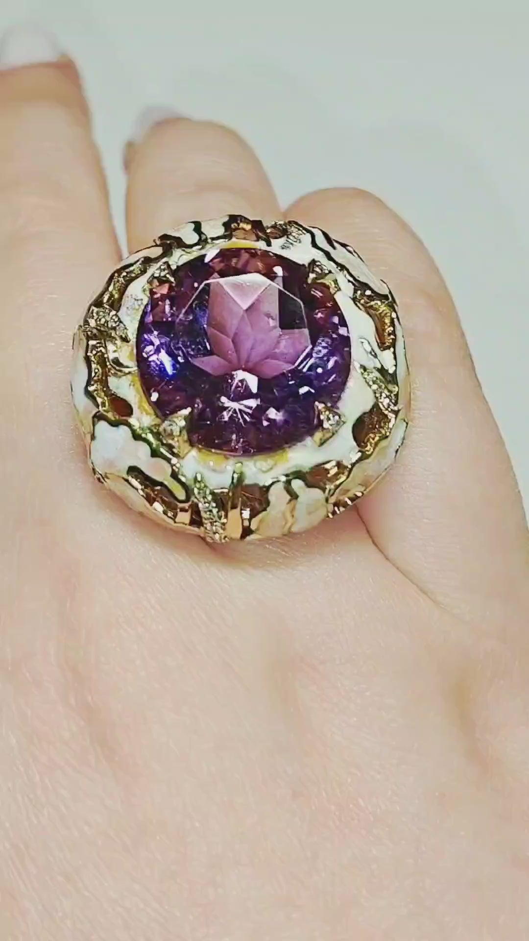 On-hand video of the ametrine lily ring, showcasing the 32 ct ametrine gemstone, hand-painted enamel lilies set with pink sapphires, and sparkling 0.34 ct diamond accents in an artisan statement design by Konforti Jewelry.