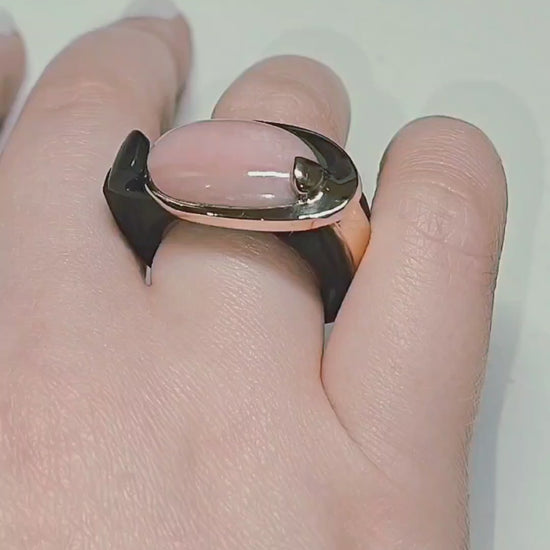 Modern Muse ring by Konforti Jewelry featuring a natural pink opal cabochon set in solid 14K pink gold with a hand carved black ebony wood sculptural band, shown in motion and worn on hand to highlight craftsmanship, materials, and contemporary design from the Stone Garden Collection