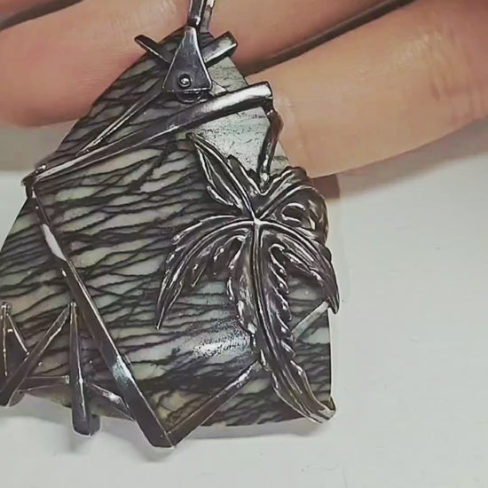 Video showcasing the Weaver of Dreams pendant by Konforti Jewelry, featuring a 51.3 ct landscape jasper set in handcrafted 925 silver with artistic silver tarnishing. Camera movement highlights the natural scenery patterns, the depth of the gemstone, and the fine craftsmanship of the Stone Garden Collection.