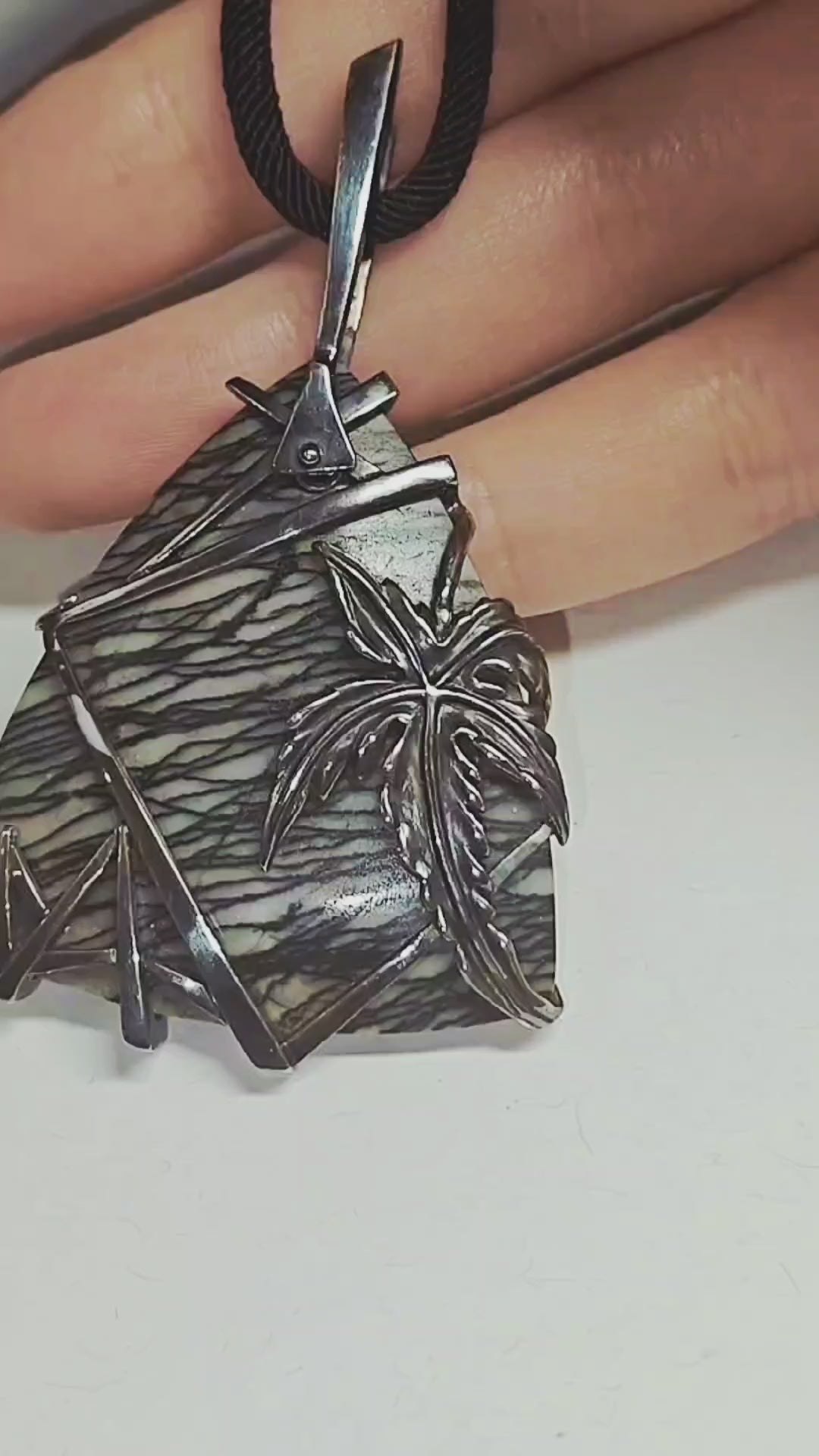 Video showcasing the Weaver of Dreams pendant by Konforti Jewelry, featuring a 51.3 ct landscape jasper set in handcrafted 925 silver with artistic silver tarnishing. Camera movement highlights the natural scenery patterns, the depth of the gemstone, and the fine craftsmanship of the Stone Garden Collection.