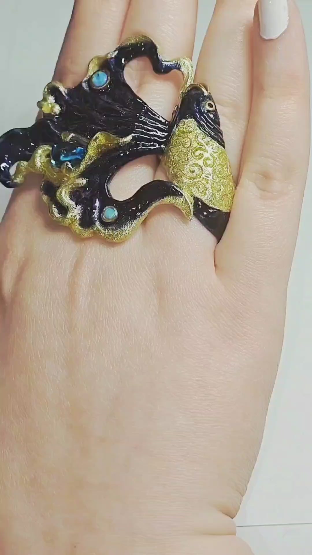 Video showcasing the Ocean Duet ring by Konforti Jewelry, handcrafted in 960 silver with a 3 ct blue topaz, 0.01 ct opal, and Limoges hot-enamel wave artwork inspired by the sea.