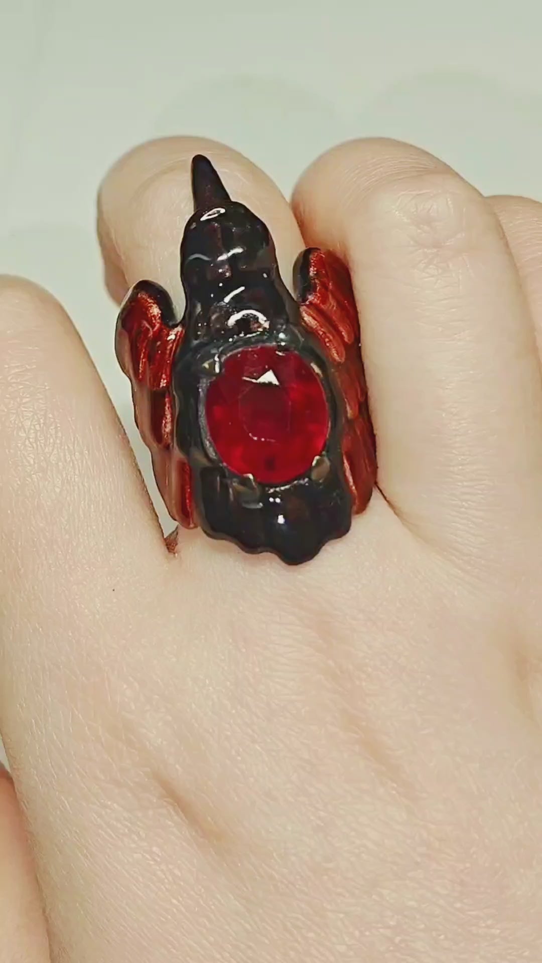 Video showcasing the Royal Raven ring by Konforti Jewelry, crafted in 960 silver with an 8.45 ct treated ruby, detailed Limoges hot-enamel artwork, and 24K gold-plated accents.