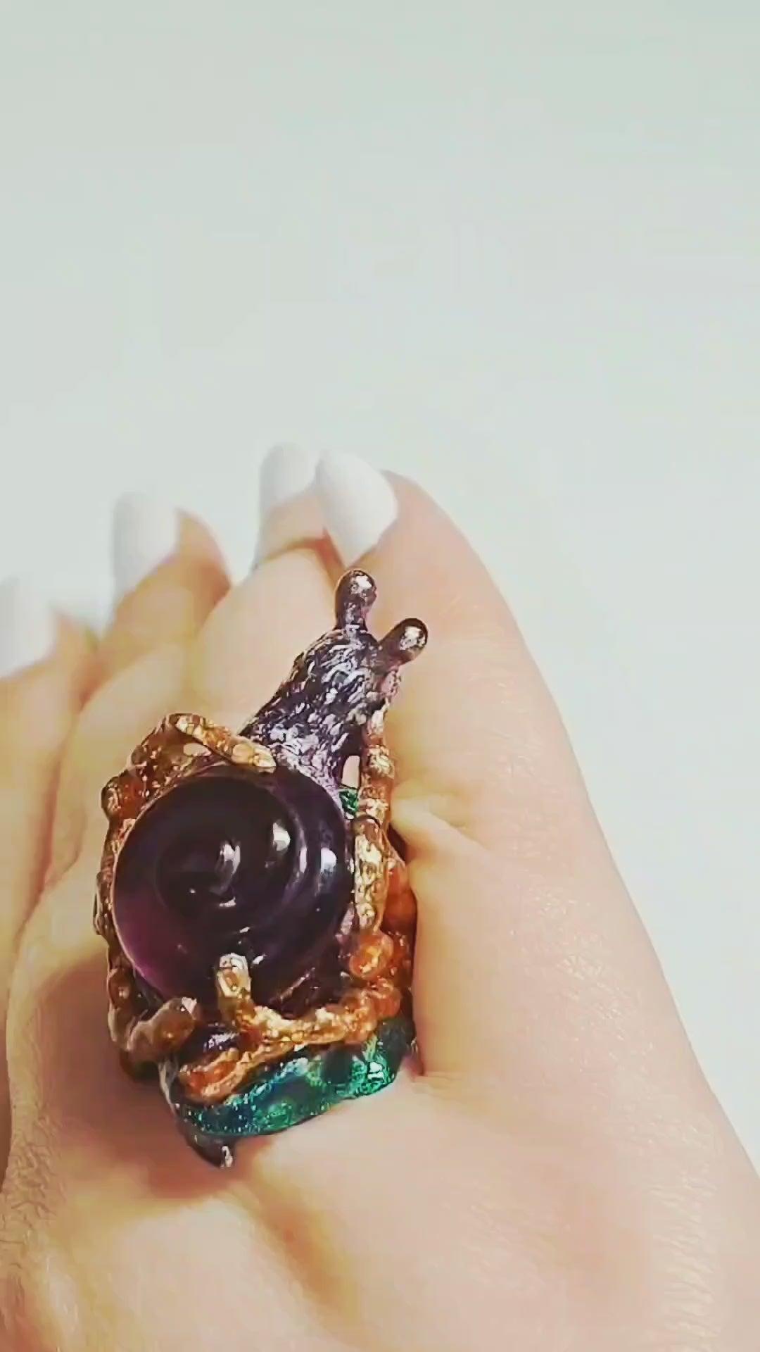 Video of the Amethyst Wanderer ring on hand, showcasing the handcrafted 960 silver snail-shell design, 29ct carved lab-grown amethyst, and vivid Limoges-style hand-painted enamel from Konforti Jewelry’s Stone Garden Collection.