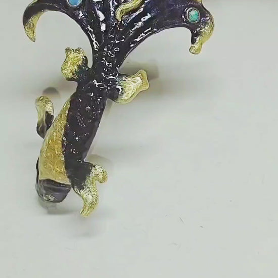 Close-up video of the Ocean Duet pendant from the Stone Garden Collection, showing the 960 silver craftsmanship, 3 ct blue topaz, 0.01 ct opal accents, and hand-painted Limoges hot enamel that creates layered ocean-wave colors. The camera moves to reveal depth, shimmer, and fine details of the sea-inspired design.