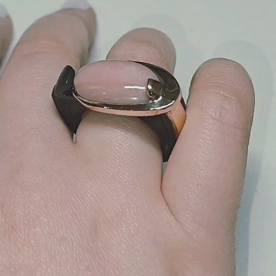 Video of the Modern Muse ring from the Stone Garden Collection, showing the 6ct pink opal center stone set in 14K pink gold with a hand-carved black ebony wood base. The rotating views highlight the opal’s soft color, the sculpted ebony craftsmanship, and the elegant contrast between the materials.