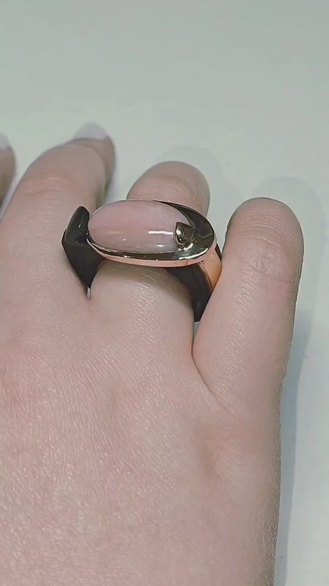 Video of the Modern Muse ring from the Stone Garden Collection, showing the 6ct pink opal center stone set in 14K pink gold with a hand-carved black ebony wood base. The rotating views highlight the opal’s soft color, the sculpted ebony craftsmanship, and the elegant contrast between the materials.