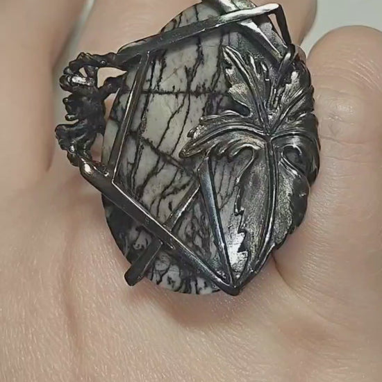Video of the Weaver of Dreams ring by Konforti Jewelry, handcrafted in 925 silver and centered with a 51.3 ct landscape jasper enhanced by artistic silver tarnishing. The video highlights the stone’s natural scenery patterns and the detailed craftsmanship of the Stone Garden Collection.
