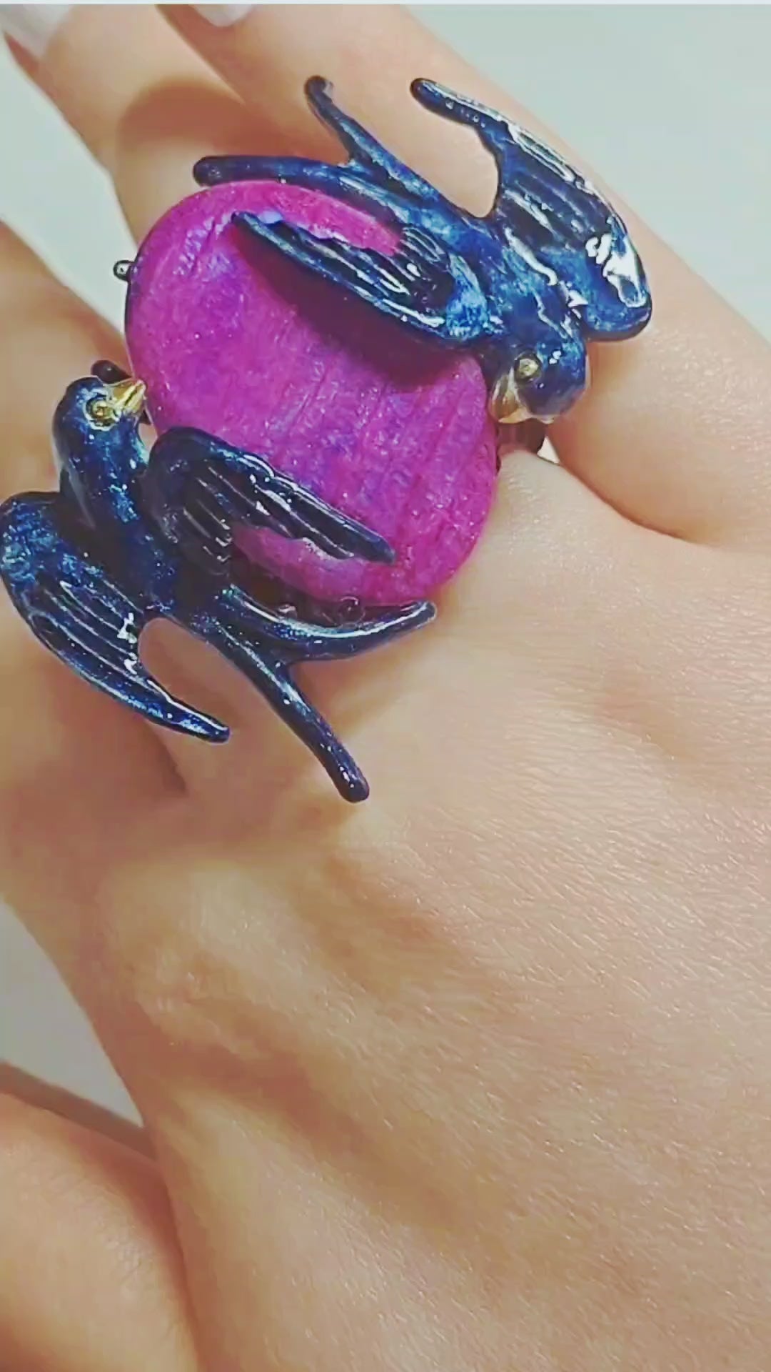 Video showcasing the Celestial Flight ring by Konforti Jewelry, featuring a hand-carved 33 ct purple moonstone set in handcrafted 960 silver with Limoges hot enamel and 24K gold-plated accents.