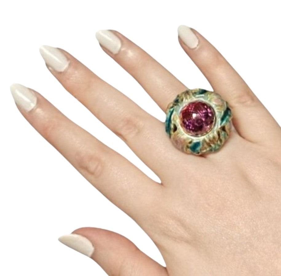 On-hand view of the Purple Thistle ring in 18K yellow gold, featuring a 27.8ct pear-shaped amethyst briolette hand-painted with vivid hot enamel and set above a plate of 1ct white sapphires.