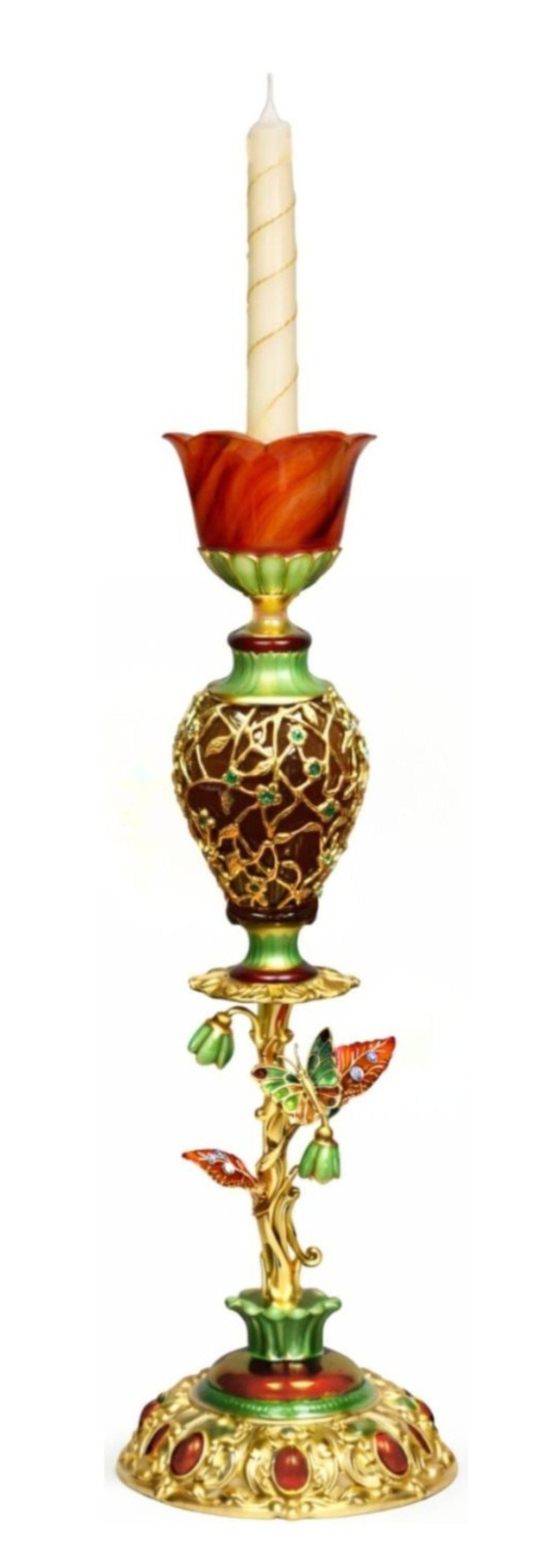 Royal Bouquet 18K gold and enamel candlestick holding candle, featuring red agate floral cup, emerald-set vine lattice body, carved gemstone leaves with blue topaz, and carnelian-set sculptural base.