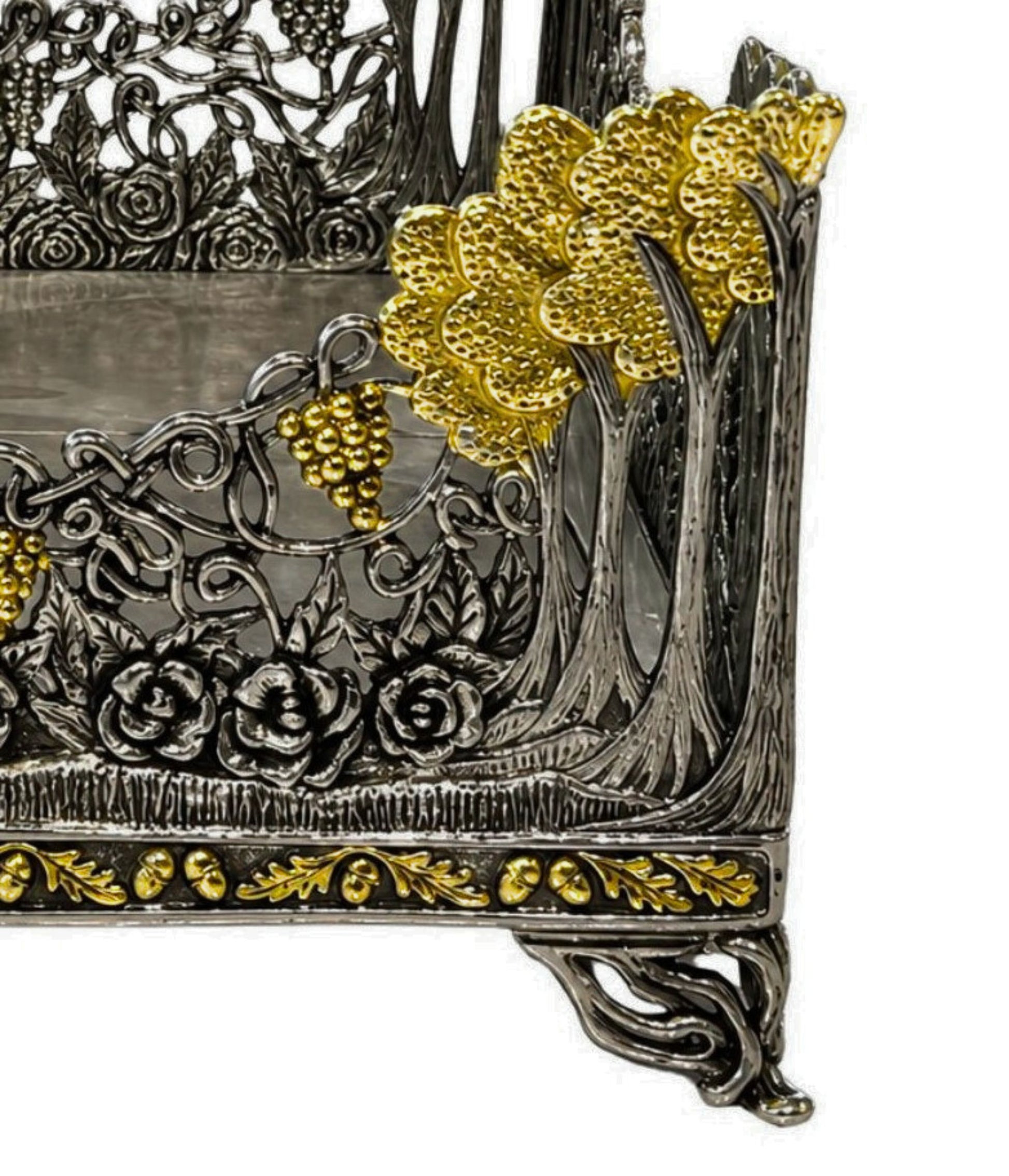 Close-up detail of gilded floral tree motif and grape cluster ornamentation on Royal Garden sterling silver napkin holder.