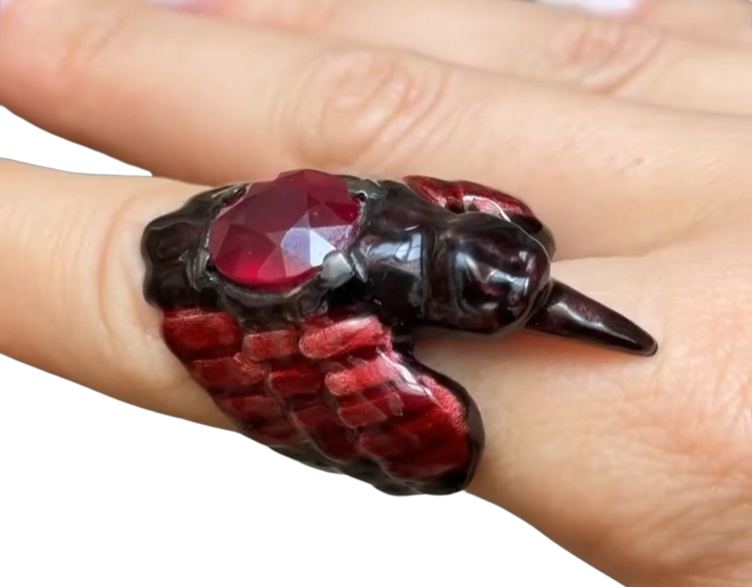 Side view of the Royal Raven ring on hand, featuring an 8.45 ct treated ruby set in handcrafted 960 silver with Limoges-style hot enamel and 24K gold-plated accents by Konforti Jewelry.