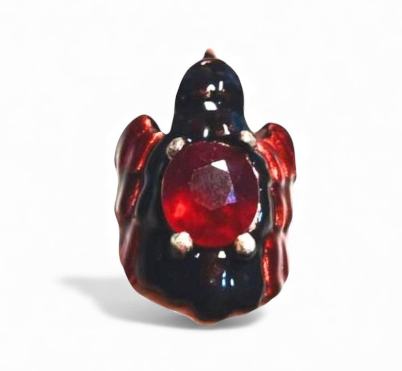 Front view of the Royal Raven ring crafted in 960 silver, crowned with an 8.45ct treated ruby and adorned with hot enamel in the Limoges technique and shimmering 24K gold-plated accents.