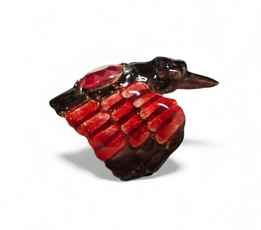 Side view of the Royal Raven ring in 960 silver, showing the raised 8.45ct treated ruby, the detailed Limoges-style enamel work along the band, and the shimmering 24K gold-plated accents.