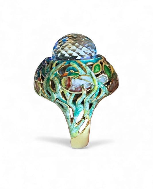 Front view of the Shimmering Pond ring featuring a pear-shaped 33.3ct Swiss topaz briolette, intricate Champlevé enamel painting, and handcrafted 18K yellow gold setting.