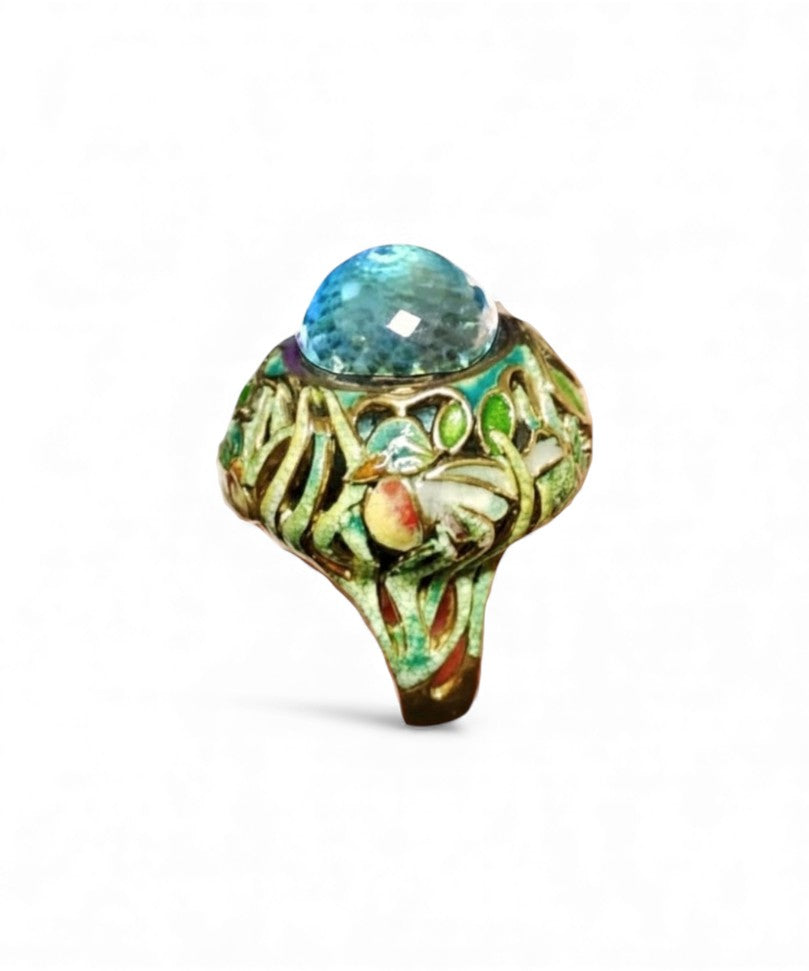 Top view of the Shimmering Pond ring highlighting the brilliance of the 33.3ct Swiss topaz gemstone and the layered Champlevé enamel artwork in the 18K gold setting.