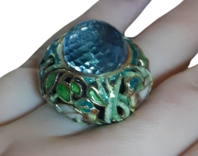 “Close-up of the Shimmering Pond ring on hand, showcasing the 33.3 ct pear-shaped briolette Swiss topaz set in handcrafted 18K yellow gold with vivid Champlevé enamel accents from Konforti Jewelry’s Stone Garden Collection.