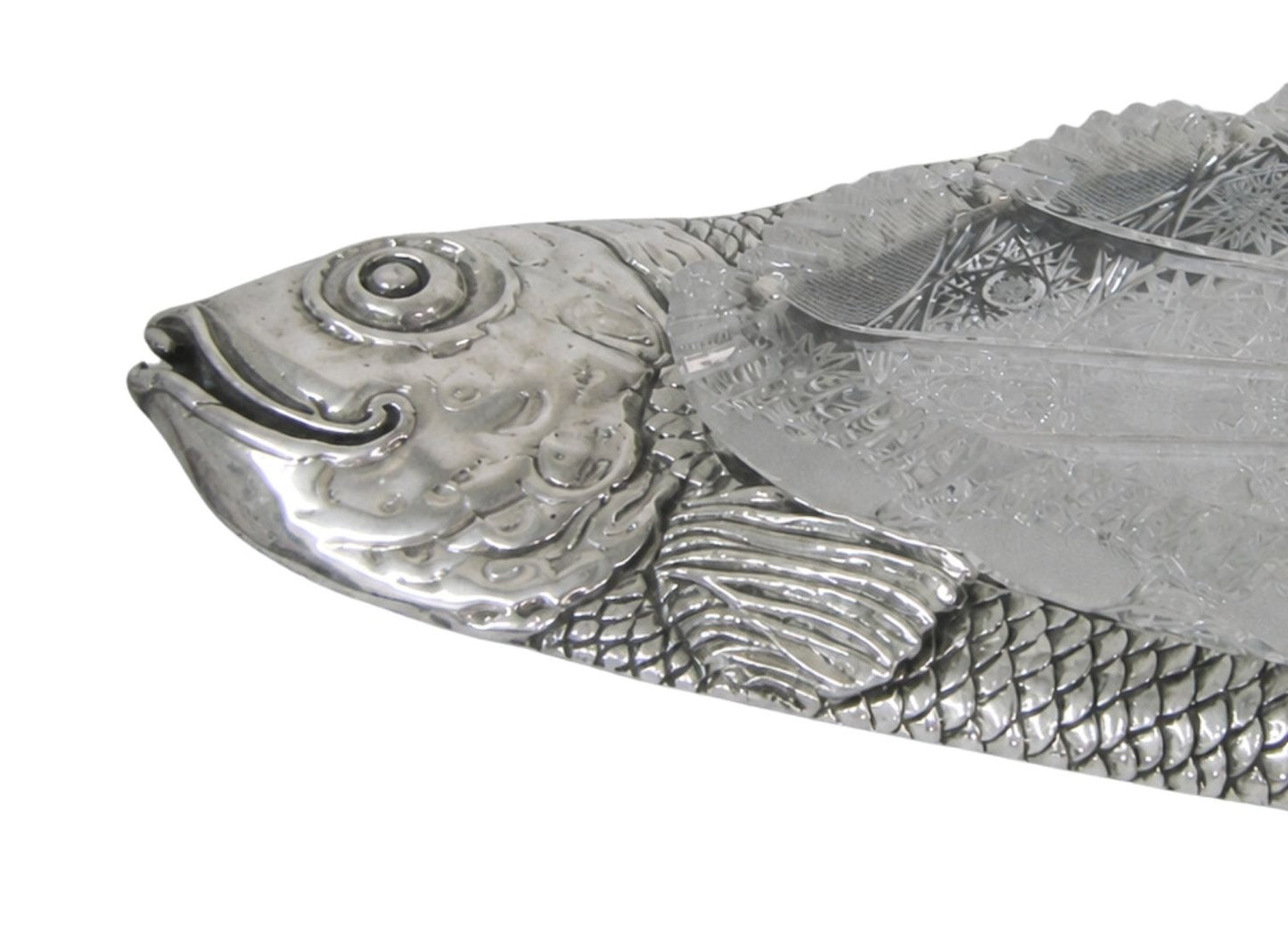 Close up of handcrafted silver carp fish head with detailed engraving, expressive eye and sculptural facial features