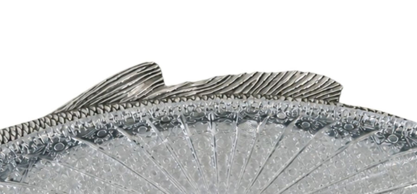 Detailed silver fish fin with hand carved lines and sculptural form, traditional silversmith technique