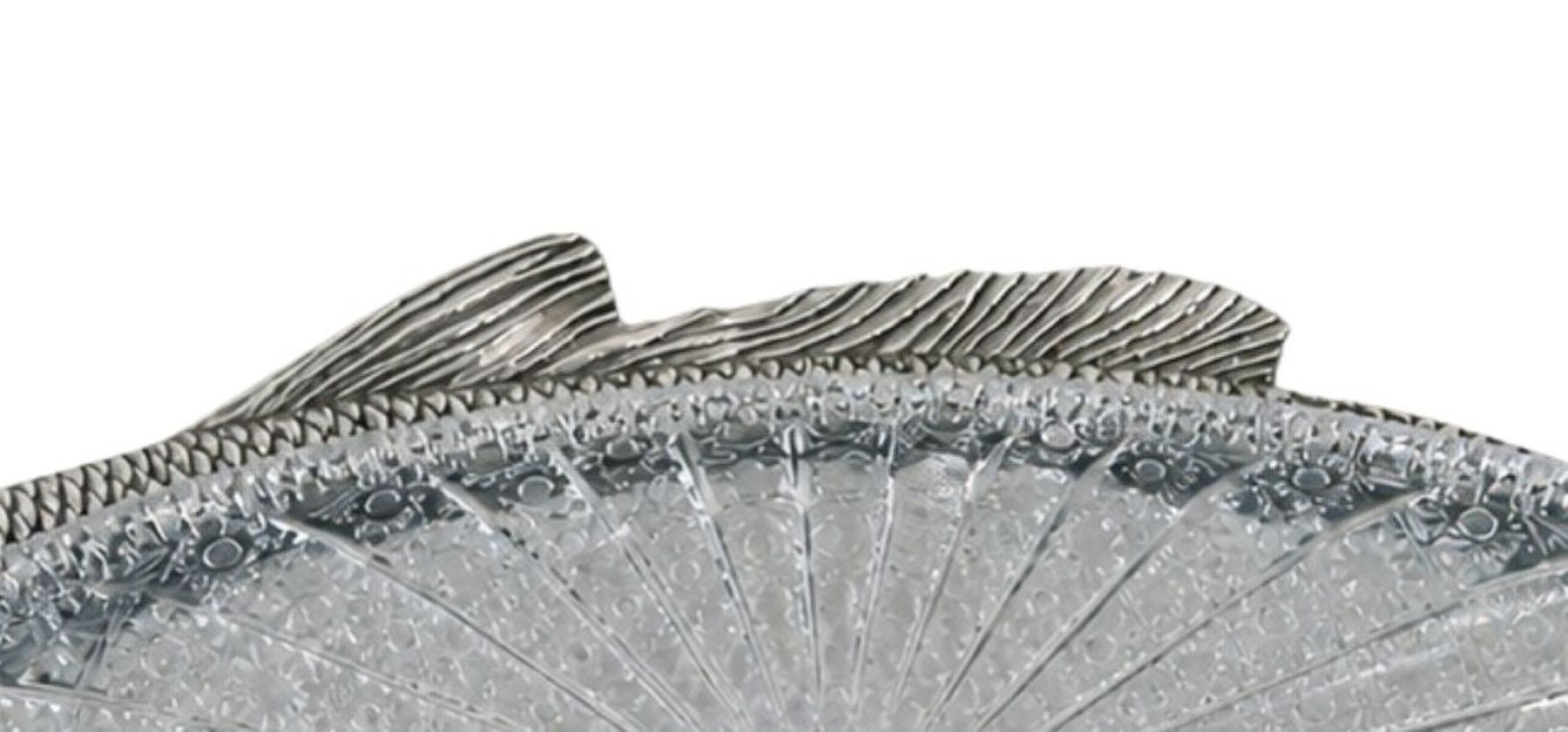 Detailed silver fish fin with hand carved lines and sculptural form, traditional silversmith technique