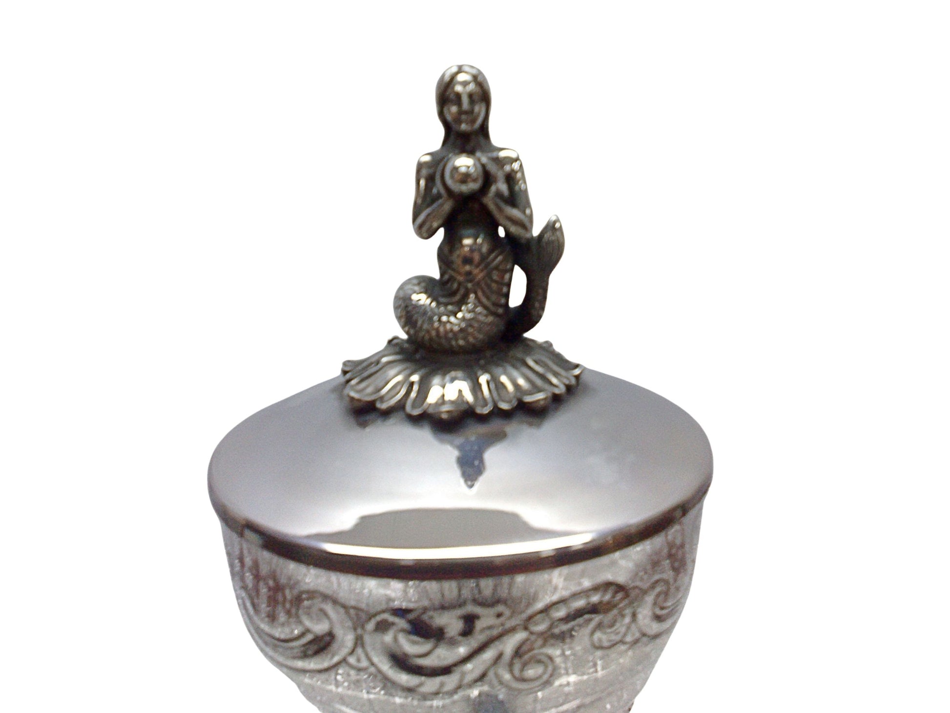 Close-up detail of the silver mermaid finial on the lid of the “Enchantress of the Sea” sculptural caviar server, highlighting hand-modeled figurative craftsmanship and refined surface detailing.