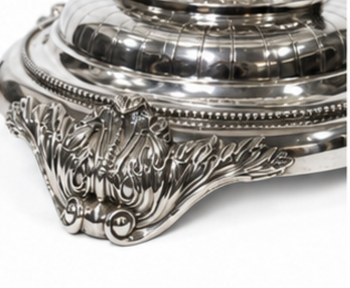 Detail of sterling silver base with hand-chased ornamentation and engraved decorative motifs on a Fabergé-inspired centerpiece vase.