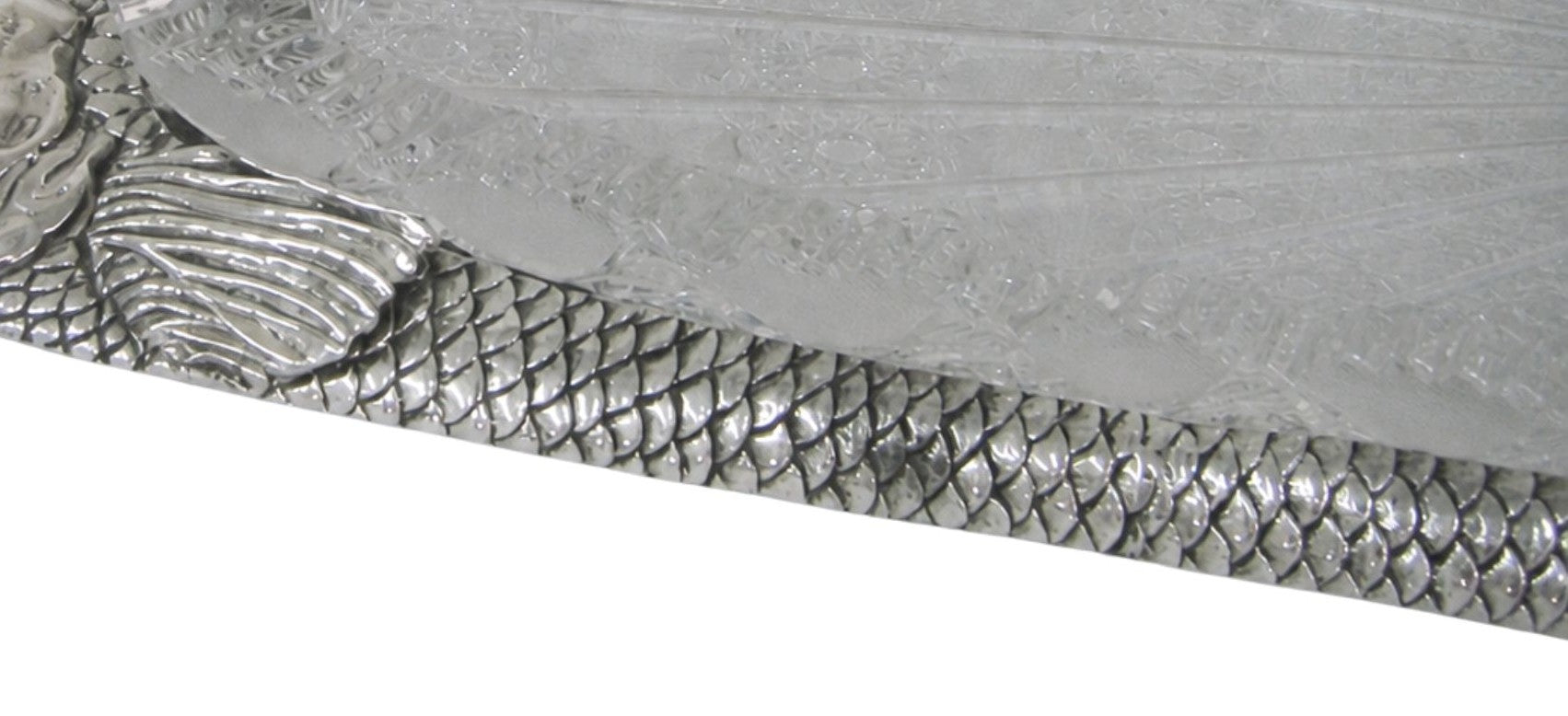Hand engraved sterling silver fish scales with textured surface, showcasing fine craftsmanship and reflective finish