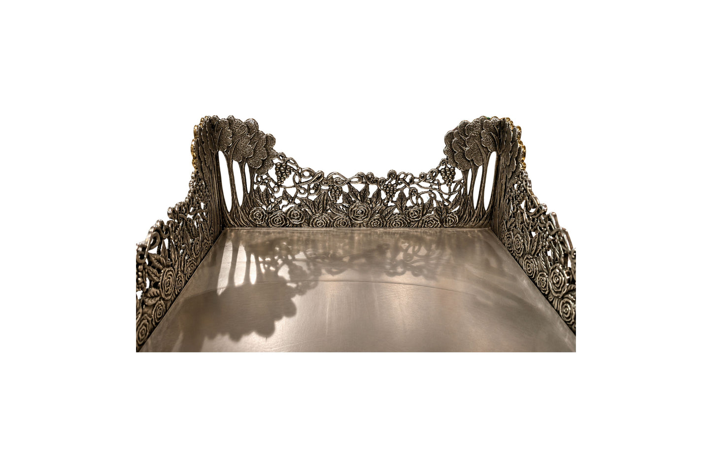 Interior view of Royal Garden sterling silver napkin holder showing mirrored base, openwork grapevine decoration, and handcrafted floral relief details.