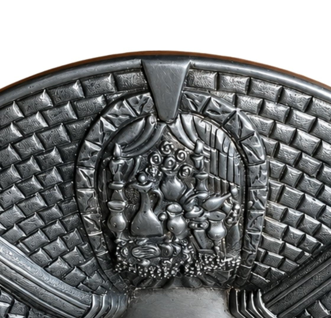 Close-up detail of the sterling silver Passover Seder plate showing an abundant festive holiday table with ceremonial vessels, fruits, and symbolic foods celebrating freedom and family gathering.
