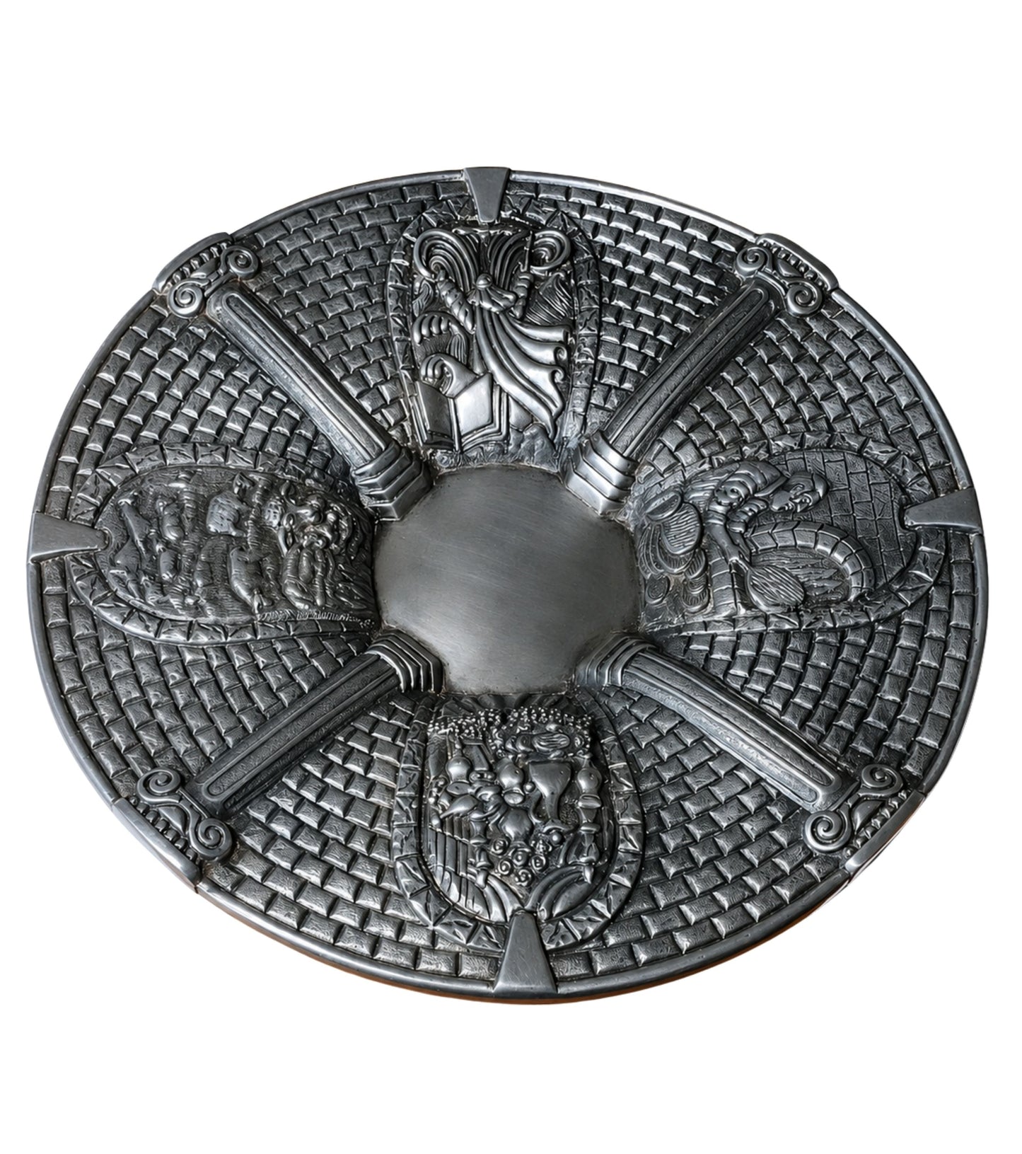 Sterling silver Passover Seder plate with four sculptural narrative relief panels depicting Moses and the Exodus, matzah preparation, the Paschal lamb, and a festive holiday table, framed by classical columns and Jerusalem stone-inspired textures.