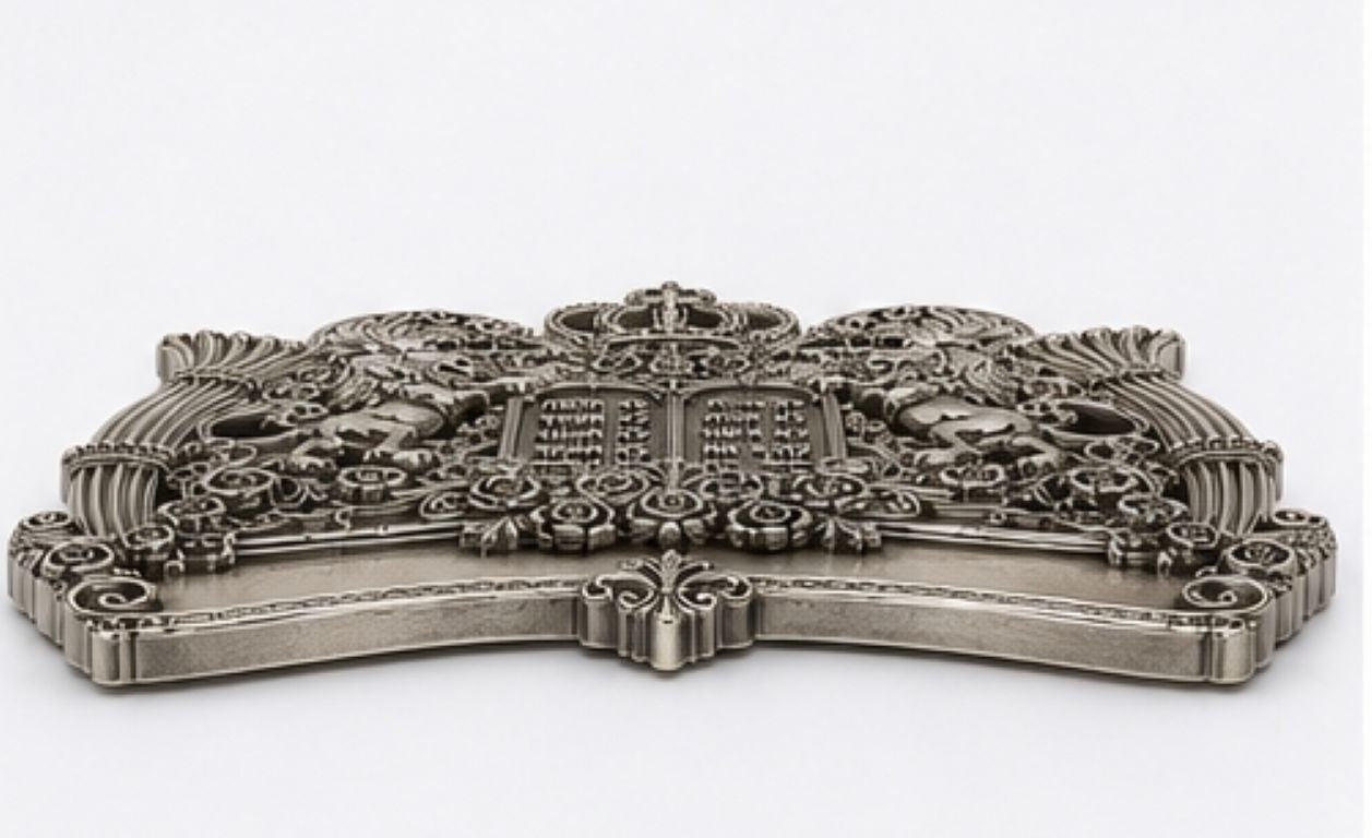 Low profile view of handcrafted sterling silver Torah shield highlighting dimensional relief sculpture, oxidized finish, crown detail, lions, and floral openwork design.