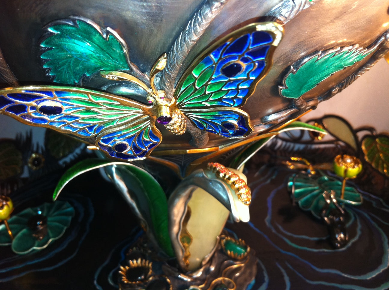 Close-up of a butterfly detail on the vase of the “Summer Pond” sculptural centerpiece, featuring fine metalwork, gemstone accents, and organic sculptural form.