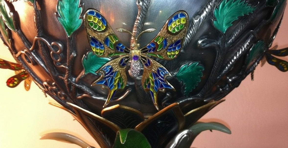 Butterfly detail on the vase of the “Summer Pond” centerpiece featuring plique-a-jour enamel wings, translucent color transitions, and fine jewelry craftsmanship.