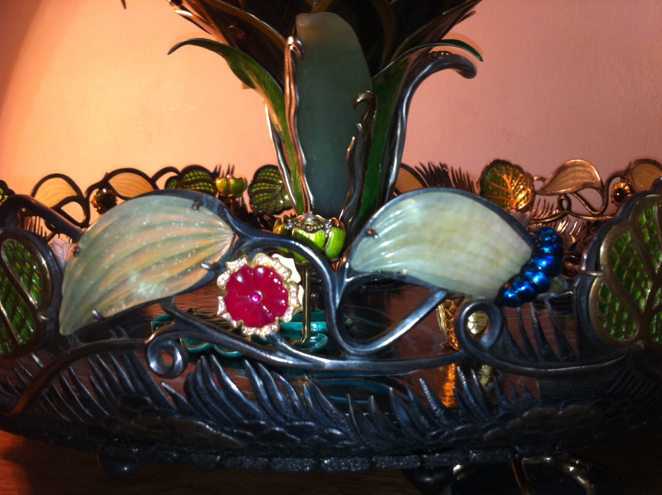 Close-up of a hand-carved ruby flower in the “Summer Pond” sculptural centerpiece, highlighting gemstone carving, color saturation, and organic floral form.