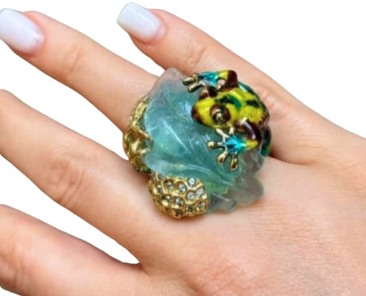 On-hand view of the Summer Pond ring in 18K yellow gold featuring a hand-carved 64ct aquamarine, hot enamel artwork, and multi-color sapphire accents.