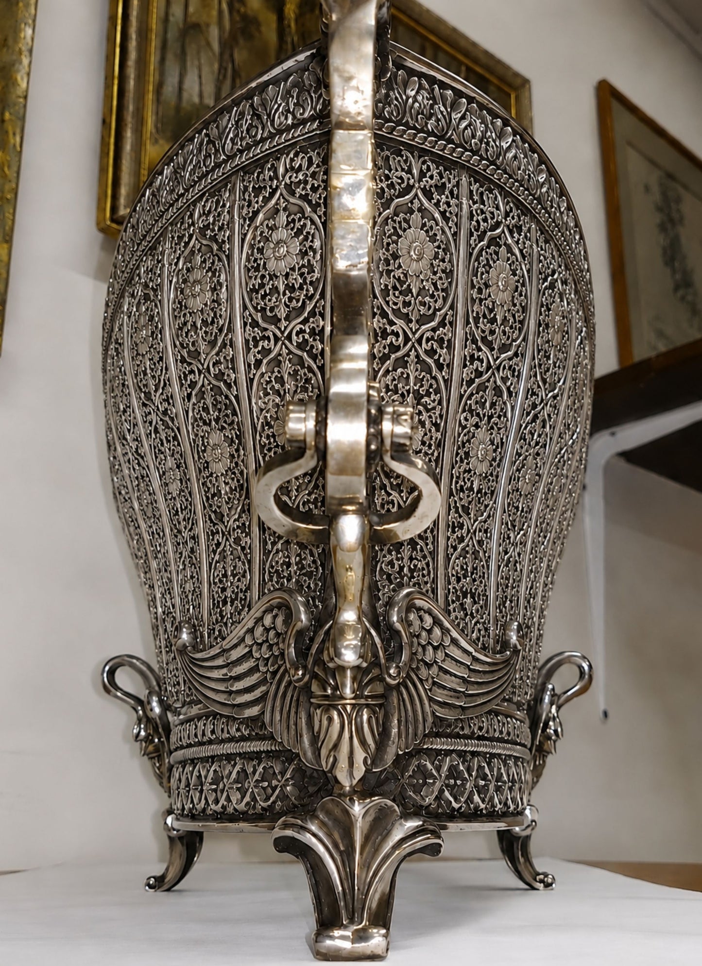 End profile of Swan Fidelity handcrafted sterling silver centerpiece vase revealing deep openwork floral panels, architectural curvature, and sculptural swan embellishments.
