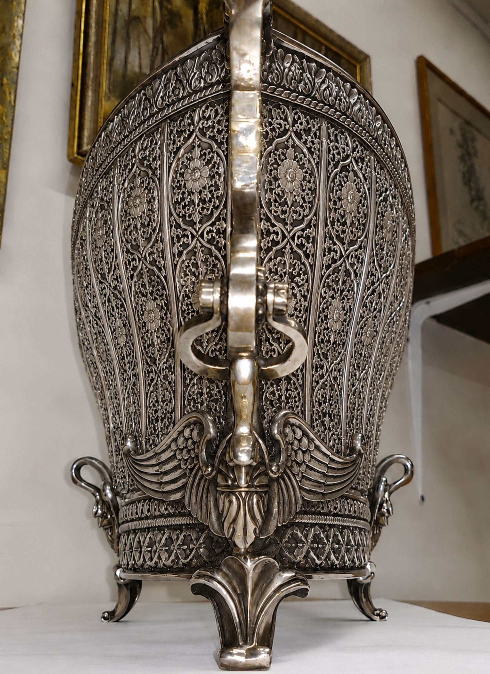 End profile of Swan Fidelity handcrafted sterling silver centerpiece vase revealing deep openwork floral panels, architectural curvature, and sculptural swan embellishments.