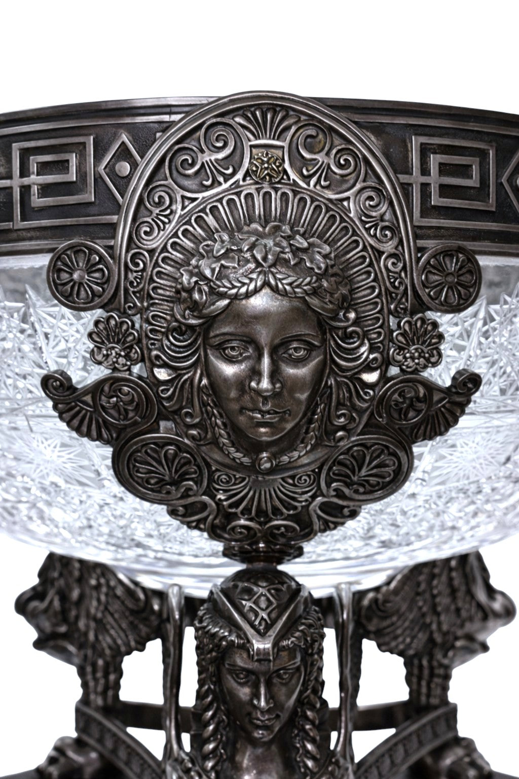 Close-up of sculpted female figure medallion on sterling silver centerpiece inspired by classical mythology.