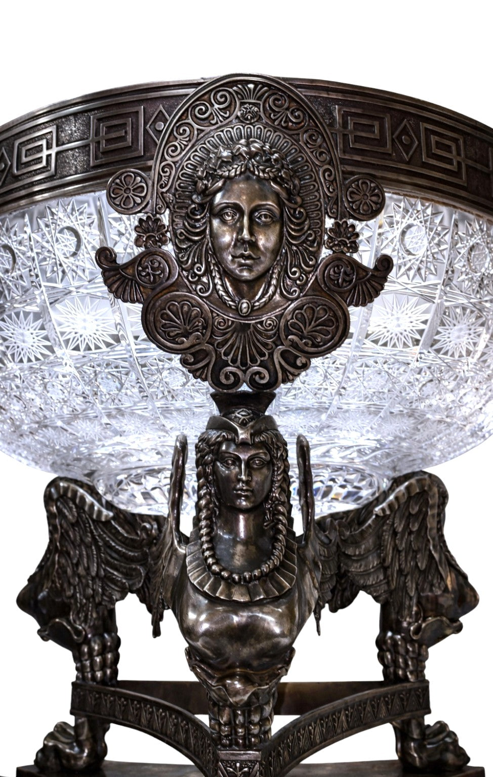 Winged female sculptural support in monumental sterling silver centerpiece, classical mythological design.